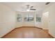 Bright, open dining room with hardwood floors, a ceiling fan, and three large windows at 3603 Cr 626N, Bushnell, FL 33513