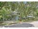 Home exterior shot showcasing the carport and lush surroundings at 3603 Cr 626N, Bushnell, FL 33513