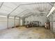 Interior of the spacious metal garage, featuring shelving, tools, and plenty of storage space at 3603 Cr 626N, Bushnell, FL 33513