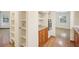 Kitchen view with shelves and oven, flowing into another room at 3603 Cr 626N, Bushnell, FL 33513