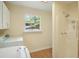 Bright laundry area equipped with white appliances and a shower stall at 3603 Cr 626N, Bushnell, FL 33513