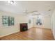 Bright living room with hardwood floors, a charming fireplace, and natural light through large windows at 3603 Cr 626N, Bushnell, FL 33513