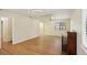 Bright living room with hardwood floors, a charming fireplace, and natural light through large windows at 3603 Cr 626N, Bushnell, FL 33513