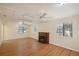 Bright living room with hardwood floors, a charming fireplace, and natural light through large windows at 3603 Cr 626N, Bushnell, FL 33513