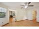 Bright living room with hardwood floors, ceiling fan and an open view to a fireplace and staircase at 3603 Cr 626N, Bushnell, FL 33513