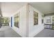 View of the porch with a blue door, windows and vinyl siding at 3603 Cr 626N, Bushnell, FL 33513