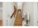 Staircase with a wooden handrail and a stair lift for accessibility at 3603 Cr 626N, Bushnell, FL 33513