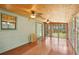 Bright sunroom with wood ceiling and hardwood floors at 3603 Cr 626N, Bushnell, FL 33513