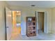 Bedroom with a wood display case, a walk-in closet, neutral walls, and connecting doorways creates a functional space at 8872 Sw 92Nd Pl # E, Ocala, FL 34481