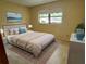 Bright bedroom features neutral paint, carpet, a large window, and staged decor at 8872 Sw 92Nd Pl # E, Ocala, FL 34481
