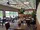Elegant dining room with dark wood tables, comfortable chairs, a full bar, and large windows for abundant natural light at 8872 Sw 92Nd Pl # E, Ocala, FL 34481
