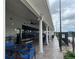 Exterior view of building with decorative columns and outdoor seating area, providing a shaded space for relaxation and socializing at 8872 Sw 92Nd Pl # E, Ocala, FL 34481