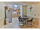 Eat-in kitchen with a refrigerator, lots of wood cabinets and a round breakfast table at 8872 Sw 92Nd Pl # E, Ocala, FL 34481