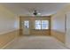 Bright living room with neutral walls and carpet, large window, and ceiling fan at 8872 Sw 92Nd Pl # E, Ocala, FL 34481
