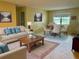 Bright living room with comfy seating, coffee table, and dining area at 8872 Sw 92Nd Pl # E, Ocala, FL 34481