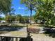 Scenic neighborhood view showcases mature trees and well-maintained landscaping in a peaceful setting under a blue sky at 8872 Sw 92Nd Pl # E, Ocala, FL 34481