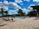 Outdoor pool with lounge chairs, umbrellas and palm trees, surrounded by brick pavers creating a luxurious resort-style experience at 8872 Sw 92Nd Pl # E, Ocala, FL 34481