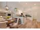 Modern kitchen with white cabinets, breakfast bar, and a dining area at 582 Caledonia Pl, Sanford, FL 32771