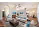 Open concept living room with hardwood floors and views into the kitchen and dining area at 582 Caledonia Pl, Sanford, FL 32771