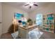 Home office features a large desk, built-in shelving, and hardwood floors at 582 Caledonia Pl, Sanford, FL 32771