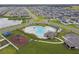 Aerial view of community pool, playground, and surrounding neighborhood at 1122 James Paul Rd, Davenport, FL 33837