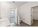 Bright bathroom with double sinks, quartz counters, toilet and walk-in closet at 1122 James Paul Rd, Davenport, FL 33837