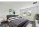 Relaxing bedroom with plush bedding, soft lighting, and a view of the outdoors through bright windows at 1122 James Paul Rd, Davenport, FL 33837