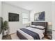 Modern bedroom with plush bedding, a mounted TV, and contemporary decor at 1122 James Paul Rd, Davenport, FL 33837