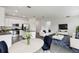 Open concept living area features stainless steel appliances, white cabinets and a cozy sitting area at 1122 James Paul Rd, Davenport, FL 33837