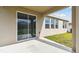 Back patio with sliding glass door access to interior at 1122 James Paul Rd, Davenport, FL 33837