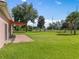 Backyard view showcasing a spacious lawn and a patio at 431 Bay Leaf Dr, Kissimmee, FL 34759