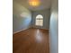 Bright bedroom with wood-look floors and an arched window at 431 Bay Leaf Dr, Kissimmee, FL 34759