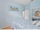 Light blue bedroom with a double bed and palm tree artwork at 431 Bay Leaf Dr, Kissimmee, FL 34759