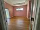 Bedroom with light pink walls and wood-look floors at 431 Bay Leaf Dr, Kissimmee, FL 34759