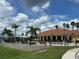 Community pool with clubhouse and palm trees at 431 Bay Leaf Dr, Kissimmee, FL 34759