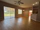 Spacious living room with wood-look floors and sliding glass doors to backyard at 431 Bay Leaf Dr, Kissimmee, FL 34759