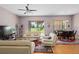 Living room with light colored furniture, hardwood floors, and access to the backyard at 431 Bay Leaf Dr, Kissimmee, FL 34759