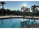 Community swimming pool with lounge chairs and lake view at 431 Bay Leaf Dr, Kissimmee, FL 34759