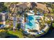 Aerial view of the community pool, showcasing its large size, lounge areas, and beautiful landscaping with palm trees at 8311 Foster Dr, Davenport, FL 33896