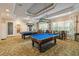 Billiard room with two pool tables, decorative lighting, and comfortable seating for residents' entertainment at 8311 Foster Dr, Davenport, FL 33896