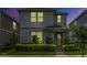 Charming two-story home featuring a beautifully landscaped front yard and stylish architectural details at 14234 Lanikai Beach Dr, Orlando, FL 32827