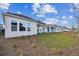 Row of houses showcasing a light-colored exterior with covered patios and grassy yards at 3057 Bootlace Way, Saint Cloud, FL 34771