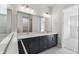 Modern bathroom featuring double vanity and a walk-in shower at 3068 Bootlace Way, St Cloud, FL 34771
