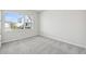 Bright bedroom with grey carpet and a large window at 3068 Bootlace Way, St Cloud, FL 34771