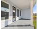 Light blue covered patio with access from the house and a view of the backyard at 3068 Bootlace Way, St Cloud, FL 34771