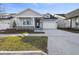 New single-story home with light blue siding, stone accents, and a two-car garage at 3068 Bootlace Way, St Cloud, FL 34771