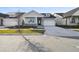 Two-story craftsman style home with light gray siding and a covered porch at 3068 Bootlace Way, St Cloud, FL 34771