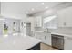Bright kitchen features white cabinets, quartz countertops, and an island at 3068 Bootlace Way, St Cloud, FL 34771