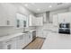 Modern kitchen with white cabinets, stainless steel appliances, and herringbone backsplash at 3068 Bootlace Way, St Cloud, FL 34771