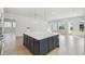 Open kitchen with a large island and dark-colored cabinetry at 3068 Bootlace Way, St Cloud, FL 34771